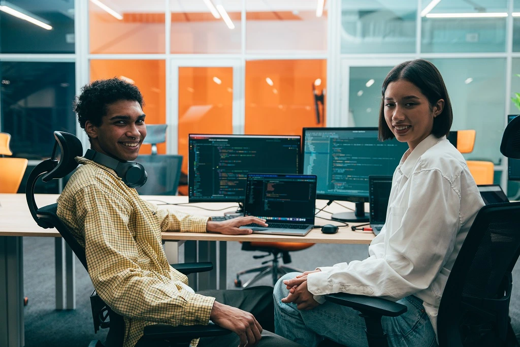 programmers collaborating on software deployment in a modern office